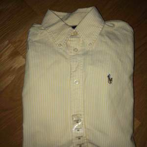 Gul-vitrandig Ralph Lauren skjorta, aldrig använd med prislappen kvar! Därav nyskick. Frakt tillkommer! 