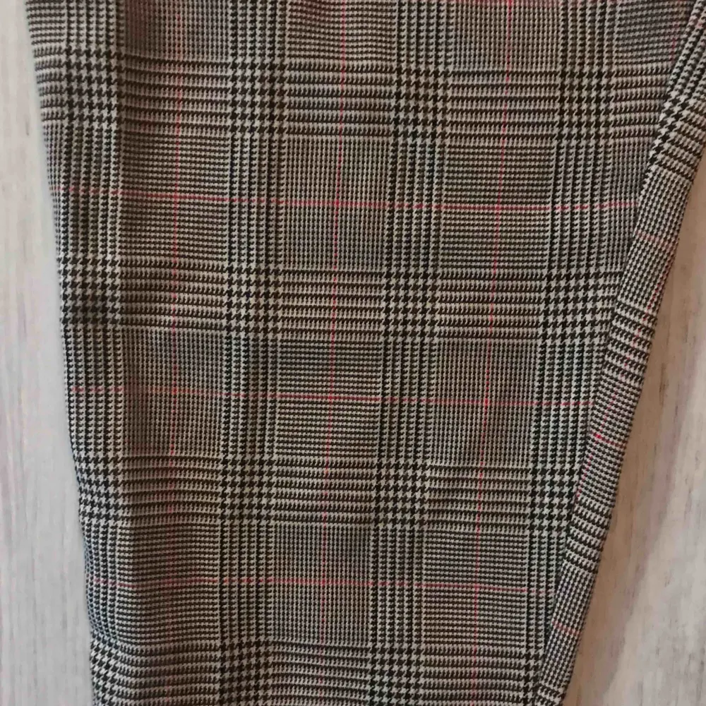 Storlek: 42, petite.   Rutiga byxor från Bohoo som aldrig är använda (lappen är kvar) i brun/svart och röd.   100 kr + frakt 🥰. Jeans & Byxor.