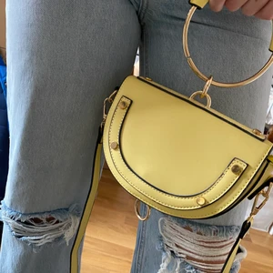 Handväska Från Nelly - Gul handväska från Nelly. Helt oanvänd. Funkar som handväska eller med axelrem. Stängs med en magnet. Supercool verkligen men inte fått användning för den!💛 Kan skickas mot frakt!