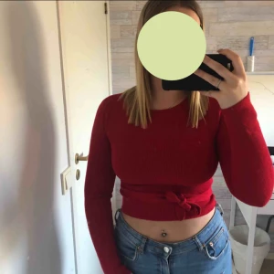  - Säljer en jätte fin röd croppad tröja med snören som går att knyta.  Storlek S men passar även mig som M. Sparsamt använd Fraktkostnad tillkommer