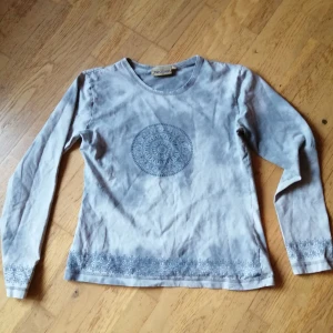Batiktop  - Dags för en högt älskad tröja att lämna boet. Grå batik med print, köpt på Indiska på 90talet! I väldigt fint skick för sin ålder. Märkt M men mer en S. Har ej möjlighet att visa hur den ser ut på. Priset är inkl vanlig frakt 