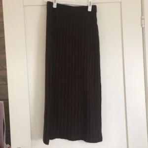 Stickad kjol - Brun stickad kjol i midilängd med slits från pretty little thing. Jättefin och mysig! Frakt tillkommer