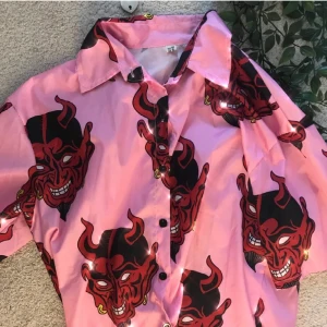 Devil skjorta  - Cool skjorta med djävulsansikten på. Köpte denna här på Plick men får ingen användning av den så säljer vidare. Fint skick! Passar XS-M beroende på hur man vill att den ska sitta. Hör av dig om du har några frågor :) 