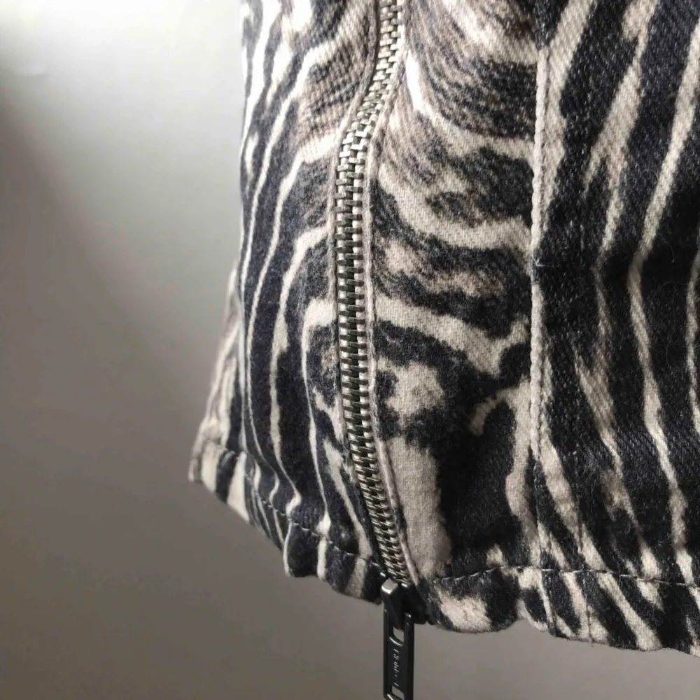 Kort jeanskjol i zebramönster. Detaljer i form av dragkedjor i sidan. Strl 36 men upplever den ganska liten. Köparen står för frakten 🦓🖤. Kjolar.