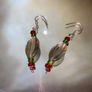Örhängen  - Ett par handgjorda örhängen med olika glaspärlor i grön, röd och genomskinlig✨ kroken är av silvertråd (frakten ingår i priset)❣️                                                                                —————————————————————                                                                                  Kika gärna in på min profil, säljer en massa olika handgjorda smycken💃🏼 perfekt till dig själv eller i present till någon❣️✨