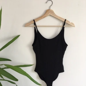  - Svart body från urban outfitters. Den är lågt skuren i ryggen och har två knappar längst ner som man sätter ihop den med. Den är som ny eftersom jag aldrig har använt den mer än en gång!