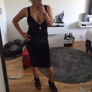  - Black velvet cleavage dress w/ slit behind 