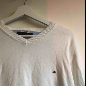  - Vit finstickad v-ringad tröja från Tommy Hilfiger. Nyskick och superbra kvalité. Frakt tillkommer till kostnaden och kan mötas upp i Västerås 😊