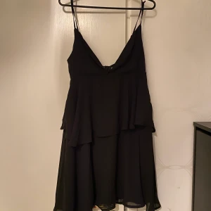 Svart klänning - Svart urringad kortklännig från Bohoo. Använd ett fåtal gånger. Strl 36.
