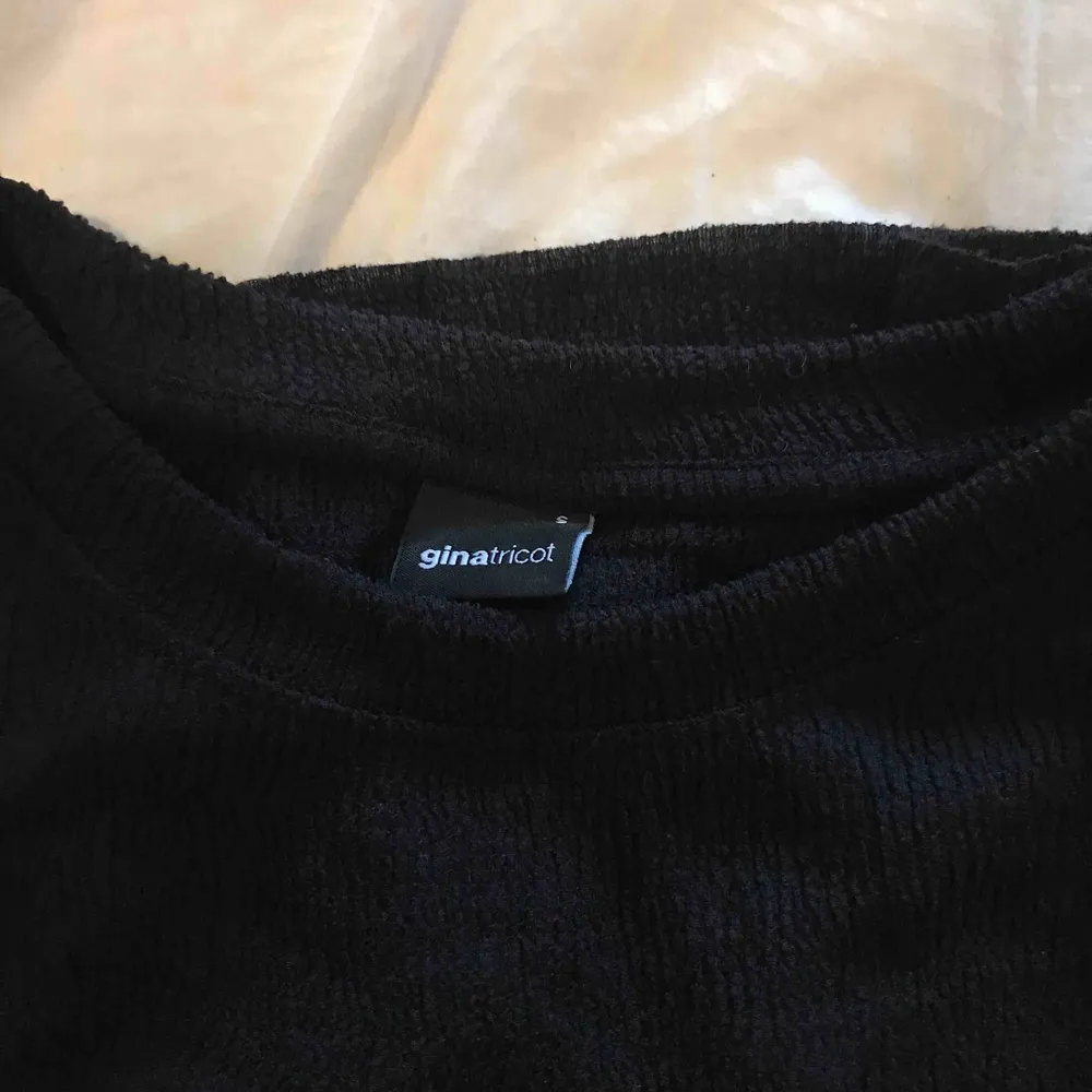 Ribbad svart T-shirt från Gina.. Skjortor.
