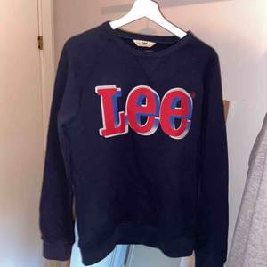 Blå Lee swetshirt med rött, vitt och blått tryck.🌸✨ Aldrig använd så är i väldigt bra skick! Frakt tillkommer!🌟