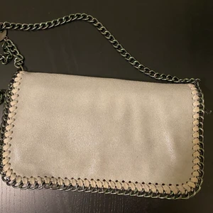 Väska - Grå mockaimitation väska med lång kedja till. Använd fåtal gånger så i bra skick! Finns en lika väska i svart uppe på min profil!:) 