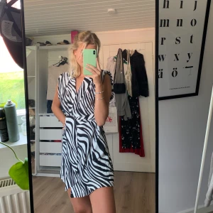 Zara klänning/playsuit  - Säljer denna balla zebra playsuiten från Zara. Det är en playsuit men ser ut som en omlottklänning framtill. Aldrig använd med prislappar kvar. Storlek xs men passar även s. Ord pris 559, mitt pris 299kr.