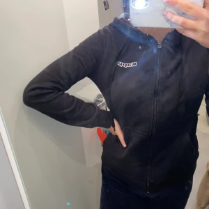 Kofta Kappa - En svart kofta med dragkedja och luva ifrån Kappa, den är i storlek xs och är i bra sick. 