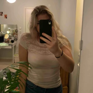  - En supersöt t-shirtblus med spets upptill.  Materialet är väldigt stretchigt & relativt tunt. 