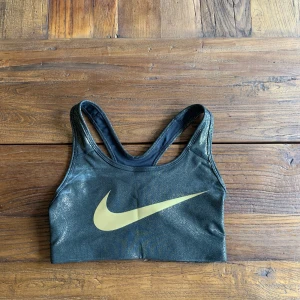 Nike sport bh - Jätte cool sport bh från Nike i skimrade guld spekell, aldrig använd och är i bra skick. 