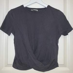 Säljer denna tshirt med omlott detalj nertill. Köpt på zara. Färgen är mörkgrå/off black. Storlek S. Använd ca 3ggr. Pris 20 + frakt. Tvättas och stryks innan frakt!💕