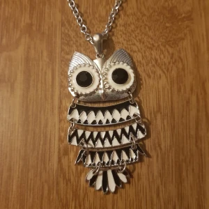 Uggle-halsband - Söt uggle-halsband. Har en knut på kedjan som jag gjort för att få en längd som passade mig. Jag får inte upp den men den stör inte heller om man vill använda halsbandets fulla längd. Säljer nu för 25kr exklusive frakt (11kr). 