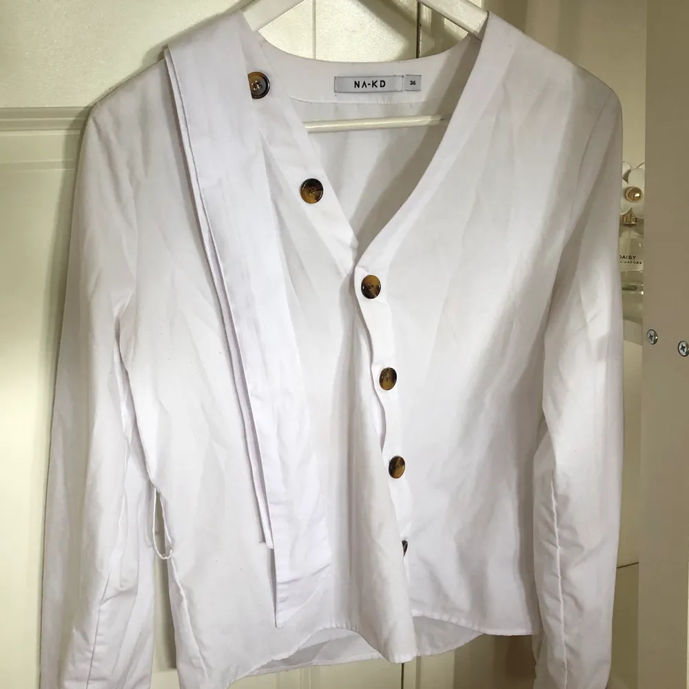 Jättefin blus/skjorta från Na-JD i vitt, med snygga knappar framtill. Tillkommer även ett avtagbart skärp. Använd bara ett fåtal gånger, därav bra skick.. Blusar.