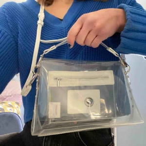 Genomskinlig väska Carin Wester  - Genomskinlig väska från Carin Wester Det finns två handtag som man kan ta av o byta Det finns även en liten ficka.   Nypris: 500kr sänkt pris:250kr