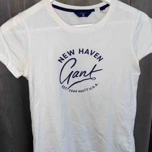 En vit t-shirt med blått tryck på bröstet/magen. Den är använd flera gånger och är suuperskön. Fungerar även för dig med storlek small. Nypris 399kr 