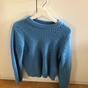 Blå stickad tröja  - En blå stickad tröja men små hål i. Stickad på olika sätt. Storlek s från gina Tricot. Väldigt fin blå färg. Synd mest på första bilden. Köparen står för frakten.