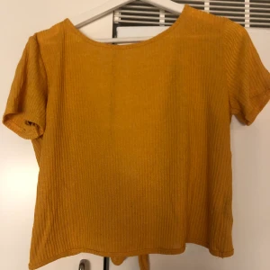 Openback tröja från H&M - säljer en orange openback tröja med knyt från H&m. Endast använd 1-2 ggr. Storlek S. Köparen står för frakt, 59kr. 