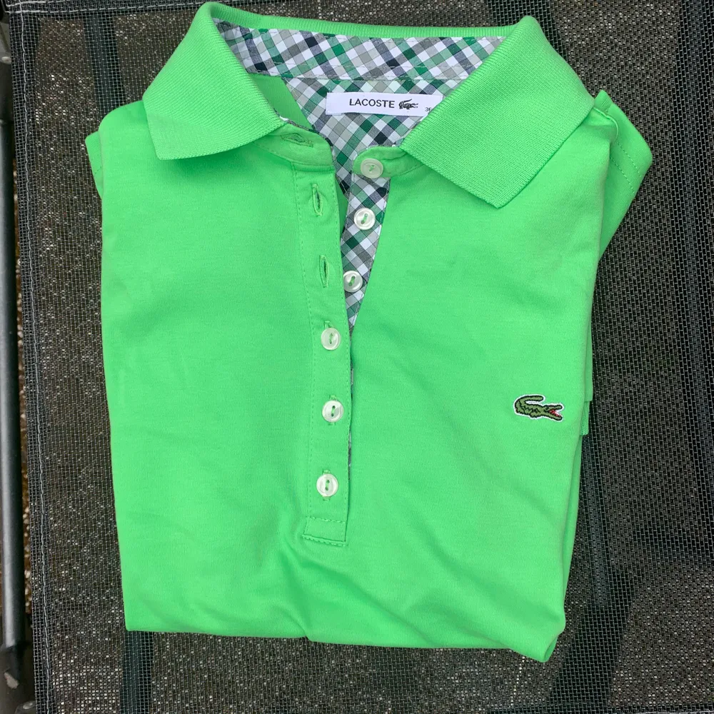 En grön lacoste skjorta som aldrig är använd och därför nyskick. Köpt utomlands så troligen fake. Skjortor.