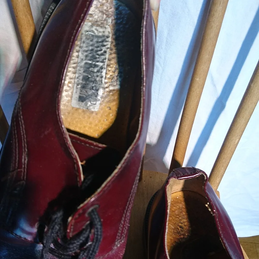 Vinröda låga skor som ser ut exakt som doc martens, men verkar inte vara det. Vintage hur som helst. Ingen storleksmärkning men bör passa runt 40. Skor.