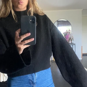 Svart stickad tröja  - Svart stickad tröja från nakd med vida armar och hög hals. Något kortare modell. Frakt tillkommer. 