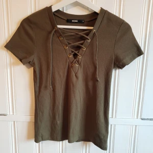  - Militärgrön t-shirt med snörning från ginatricot, fint skick! 40kr+frakt