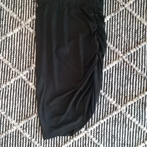 Kjol  - Svart lättribbad kjol med resår i sidan. Använd max en gång. Nyskick.