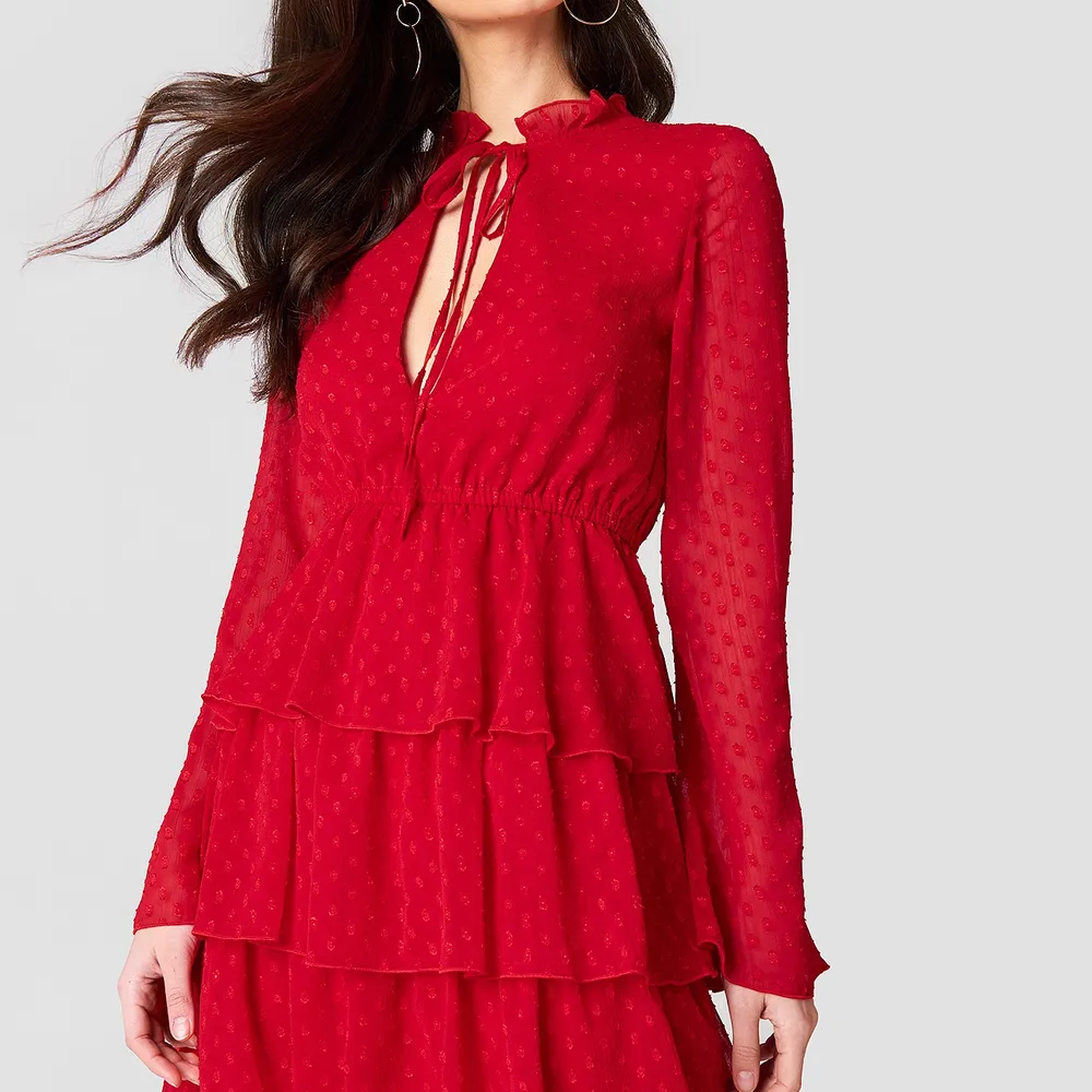 En röd långärmad klänning från Linn Ahlborg X NA-KD kollektionen, i storlek 34. Säljer då den inte kommer till användning. Använd en gång. Klänningar.