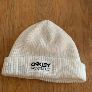  - Vit sotarmössa från märket Oakley. 