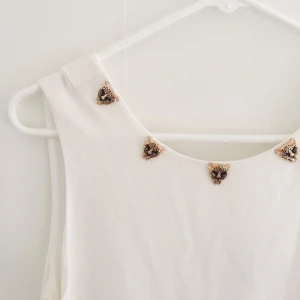  - Vit klänning med lejon detaljer, helt ny med prislapp kvar