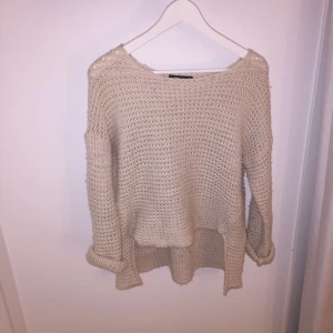  - Stickad tröja, längre vid ryggen