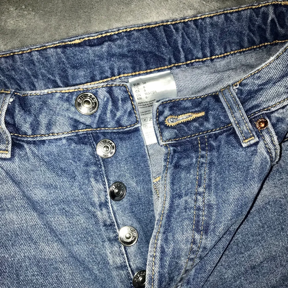 Strl. 38, blå jeans med hål, knappar inte blixtlås. Använda några få gånger men inga täcken på användning. Säljer pga för korta för mig. Jag är 170 cm lång annars passar den ganska bra för mig som brukar ha 38 på byxor. För mer bilder skriv dm . Från H&M 🥰 Frakt ingår!!. Jeans & Byxor.