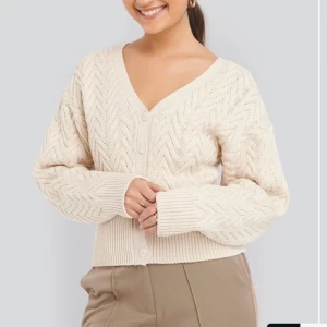 NY Stickad kofta Na-kd - Helt oanvänd stickad kofta från Na-kd, väldigt fin kvalité! Storlek XS. Frakt på 66kr tillkommer!