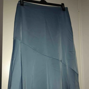  - Silkeskjol i en fin blå färg, lite längre på ena sidan (se bild 2)