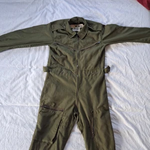 Militär overall - Militärgrön/olivgrön overall från Israel.  Storlek M skulle jag tippa på, om du kan hebreiska kanske du kan lista ut det. 5 fickor. Några små färgfläckar här och där som knappt märks, går säkert att få bort om man vill.