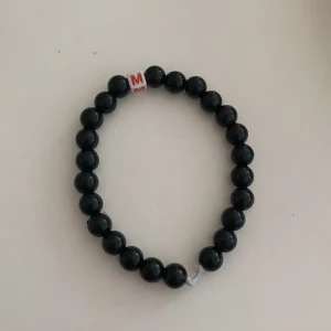 Armband - Ett svart armband med bokstaven M i mitten handgjort❤️
