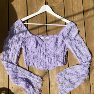 Lila tip - Croppad top i lila spets. Superfin! Mycket bra skick!