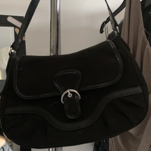 Väska  - axelremsväska, man får plats med ganska mycket (dock inga innerfickor i väskan) Knappt använd.