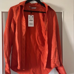 Orange skjorta - Perfekta färgen för sommarbrännan! Tyvärr har den enbart stått i garderoben och har prislapp kvar! Köpt på Zara för 399kr Säljs för 249kr! Storlek M 