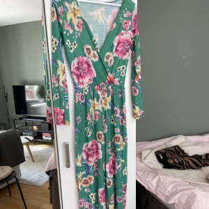 Blommig jumpsuit - Jättefin och somrig blommig jumpsuit från Nelly i storlek XS. Går ner i backen på mig som är 175 cm lång.  Kan mötas upp i Stockholm annars står köparen för frakten!
