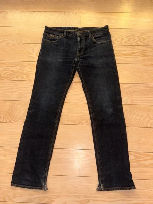 Hugo Boss jeans - Snygga raka Hugo Boss jeans! Klippta i inner kanten vid fötterna! Vid fler frågor är det bara att höra av sig!