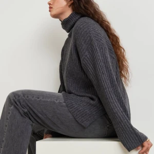 STICKAD TRÖJA FRÅN GINA TRICOT - Mörkgrå stickad tröja från Gina tricot med slita på tröjan. Köpt tröjan i butik så vet inte om det är exakt samma tröja men är ganska säker❤️