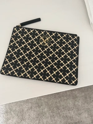 Kuvertväska  - Kuvertväska utan axelband säljes nu pga att den aldrig kommer till användning. Den är använd fåtal gånger och i superfint skick! Kostar 599 kr ny, säljes nu för 299. Mått för väskan är 16,5 cm i höjd och 22 cm i bredd. 