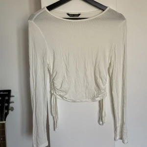 Vit långärmad tröja - Använd en gång. Är justerbar på båda sidorna. Lite genomskinlig men väldigt mjuk i materialet.