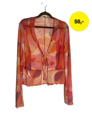 Meshtopp i glada färger  - Genomskinlig färgglad topp använd bara en gång på en fest. Festlig och färgglad.